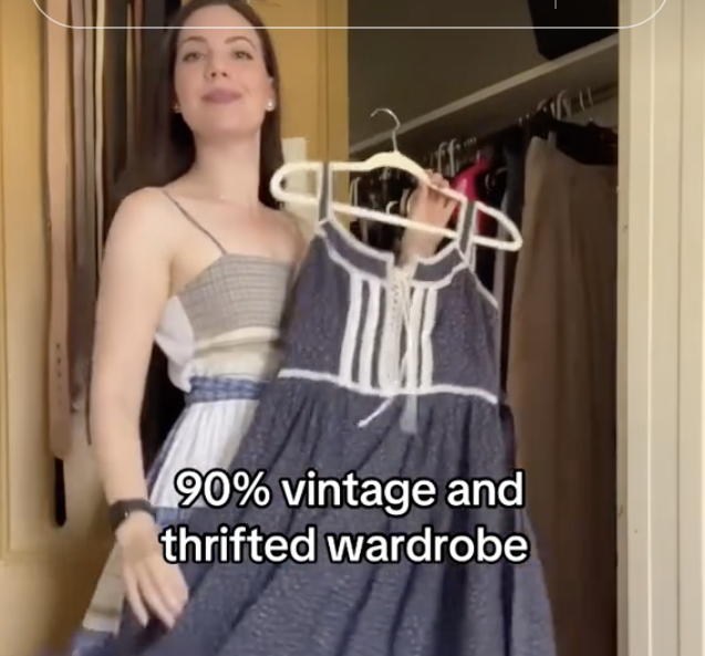 woman holding vintage dress